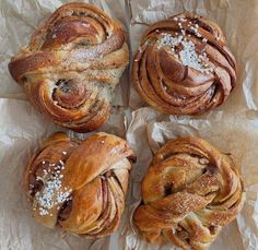 four different types of breads sitting on top of wax paper with sea salt sprinkled on them