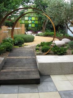 an outdoor garden with wooden steps leading up to it