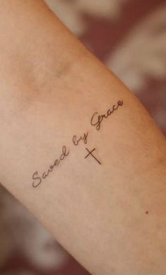 a person with a tattoo on their arm that says, sweet as grace and the cross