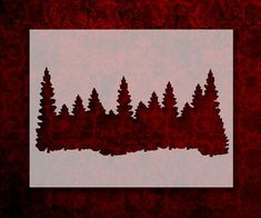 a red and white photo with trees in the middle on a textured paper background