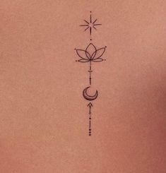 the back of a woman's stomach with an arrow and moon tattoo on it