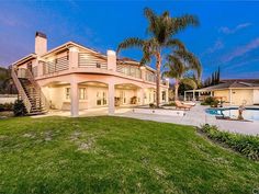 a large house with a pool in front of it