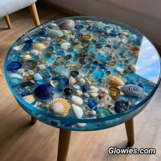 a glass table topped with lots of sea shells