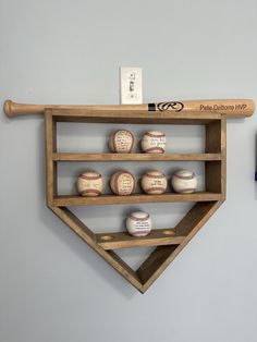 baseballs and bats are displayed on a shelf in the shape of a baseball diamond