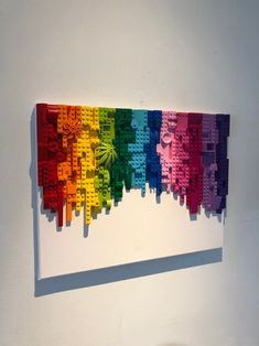 a multicolored lego wall hanging on a white wall