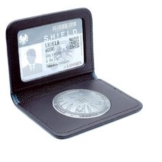 a black leather wallet with a credit card holder on the front and an image of a man's face