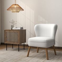 a white chair sitting next to a wooden cabinet