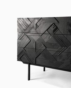 a black cabinet with geometric designs on it