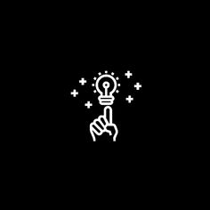 a hand holding a lightbulb with crosses and stars above it on a black background