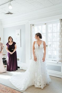 two bridesmaids are getting ready for their wedding