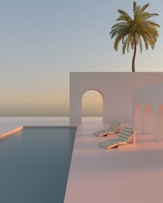 an empty swimming pool with lounge chairs and a palm tree in the background at sunset