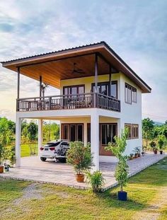 a car is parked in front of a two story house with balconys and balconies