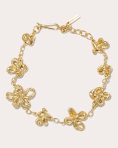 True to Completedworks' sculptural aesthetic, this 18-karat gold vermeil bracelet decorates its chain with an array of twisted floral accents to create blossoming dimension. Hook clasp closure 18k gold vermeil Polish with soft cloth Made in Thailand Measurements Length: 6.5in with 1.5in extender Sustainability Metrics: Natural Resources: at least 50% of materials used are produced with a reduced environmental impact Conflict-Free: 100% of products are recycled or conflict-free and adhere to fair Luxury White Gold Flower Bracelets, Luxury White Flower-shaped Bracelets, Luxury Formal Flower-shaped Bracelets, Luxury Formal Bracelets With Flower Shape, Luxury Bracelet With Flower Charm, Luxury Flower Bracelets In Fine Jewelry Style, Luxury Gold Flower-shaped Bracelets, Luxury Gold Bracelets With Flower Shape, Luxury Fine Jewelry Flower Bracelets