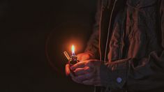 a man holding a lighter in his hands