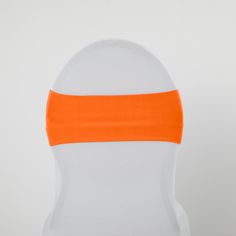 an orange band on the back of a white chair