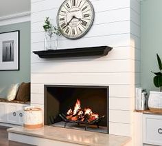 a fireplace with a clock on the wall above it