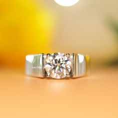 a diamond ring sitting on top of a table