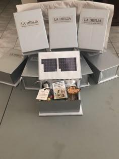 several books are stacked on top of each other in the shape of a house with solar panels