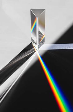 an image of a rainbow in the middle of a black and white photo with a light coming from it