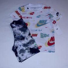 New Never Worn With Tags. Nike Set Includes A White Printed Short Sleeve Cotton Blend Tee With Red, Green, Blue, Yellow And Multi Trim And "Nike" Inscription And Classic Check Logo On Front And Left Sleeve. Bottoms Are Black Spotted Multi Color Cotton Blend Design With White Trim And Elastic Waistline And Nike Check Logo On Left Leg. 2 Pocket Design With Draw Cord. Set Fits 7 Youth Boys. Any Questions, Please Contact Me. Thanks! Fitted Nike T-shirt For Summer, Trendy White Cotton Sets, Nike Casual Cotton Sets, Nike Summer Sets With Short Sleeves, Casual Nike Cotton Sets, Casual Cotton Nike Sets, White Graphic Print Sets For Spring, Nike Short Sleeve Sets For Spring, Nike Summer Playwear Sets