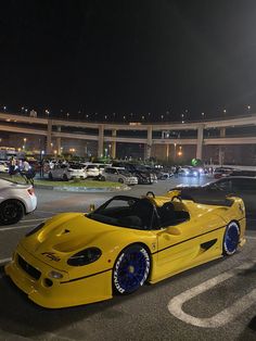 a yellow sports car parked in a parking lot