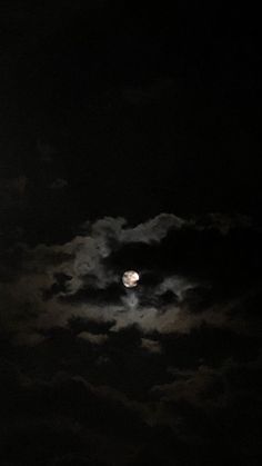 the full moon is shining brightly in the dark night sky with white clouds and black skies