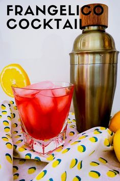 a drink in a glass next to a cocktail shaker and lemons on a table