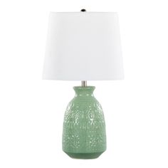 a green table lamp with a white shade