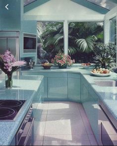 a kitchen filled with lots of counter top space next to a stove top oven and sink