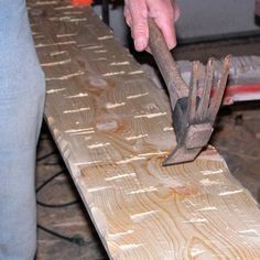 a man is working on a piece of wood