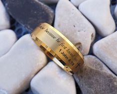 a close up of a gold ring on some rocks