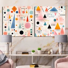 two abstract paintings on the wall in a living room with pink chairs and a coffee table