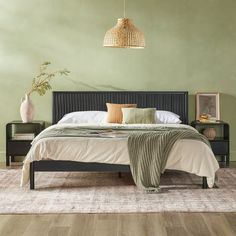 a bedroom with green walls and wooden floors