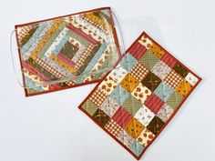 two quilted placemats sitting next to each other