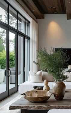 a living room filled with furniture and lots of glass doors leading to an outside patio