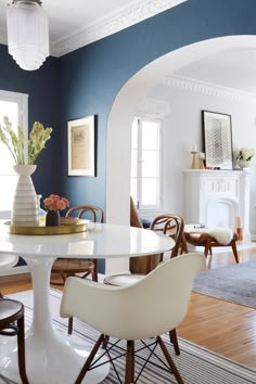 a living room filled with white furniture and lots of windows