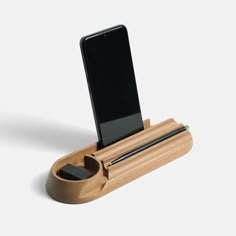 a cell phone in a wooden holder