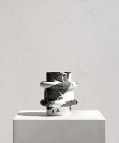 three stacked rings sitting on top of each other in front of a white wall and floor