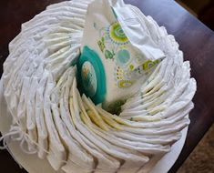 a cake with white icing and green decorations on it's top is sitting on a table