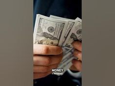 a man holding money in his hands with the words money written on it and an image of one hundred dollar bills