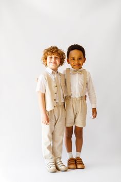 two young boys dressed in formal clothing posing for the camera