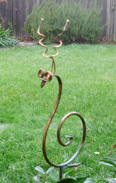 Copper snail garden sculpture by artist Catherine Murphy of Haw Creek Forge Size: Small Snail 9" Tall by 5" on 25" Display Rod $40.Large Snail 18" Tall by 8.5" on a 25" Display Rod $66. Haw Creek Forge is a small business with a big reputation for quality, originality and service. In our riverside studio in the mountains of North Carolina, a small group of talented artisans carefully craft each piece of our unique and whimsical garden art, continuing the tradition of handcrafted in America. We t