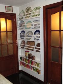 there are plates and bowls on the shelves in this room, along with other items