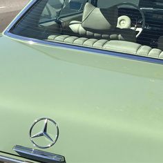 there is a mercedes car that has been parked in the parking lot for several years