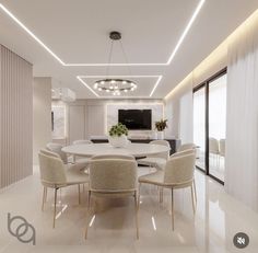 a dining room with white chairs and a large round table in the middle of it