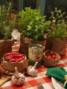 there are many vegetables on the table and in paper bags next to eachother