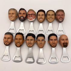 a group of men's head cut out with scissors