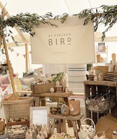 an assortment of bird figurines on display in a store with a sign that says my perceed bird