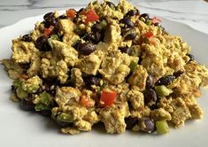 a white plate topped with eggs and black beans