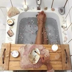 a person sitting in a bath tub with their feet up